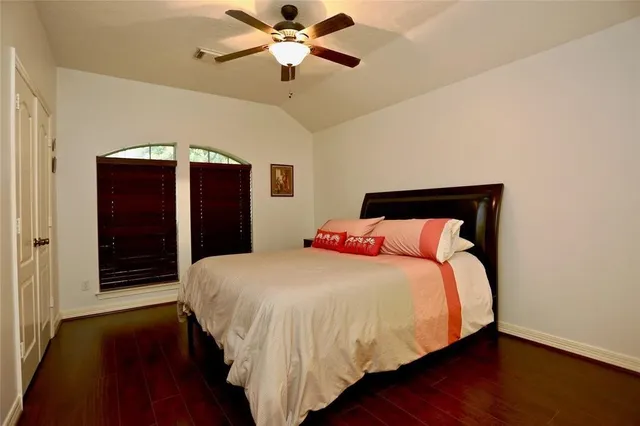 a bedroom with a bed and a ceiling fan