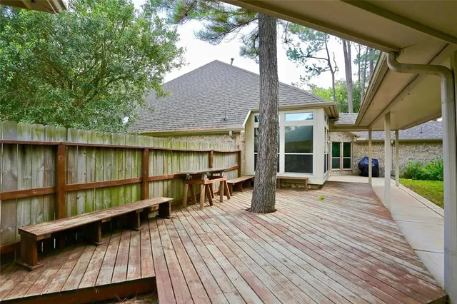a view of a house with wooden floor and outdoor seating