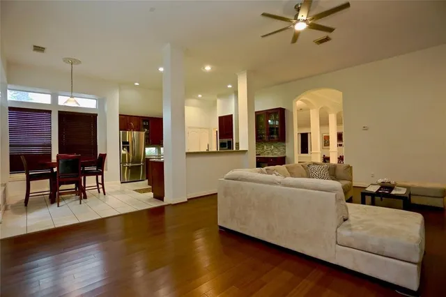 a living room with furniture and a wooden floor