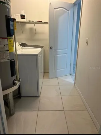 storage and utility room with washer and dryer