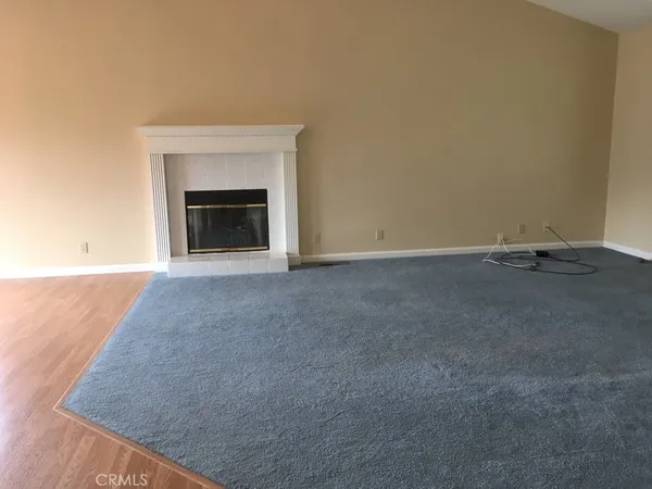 a view of an empty room with a fireplace