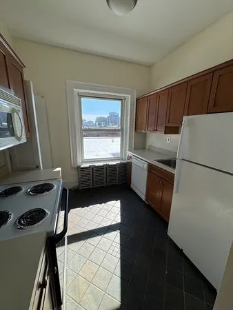 a kitchen with a refrigerator and a stove top oven