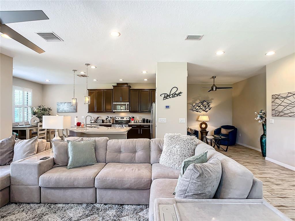 4744 Wandering Way Wesley Chapel, FL 33544 - Photo 11 of 39 a living room with furniture and kitchen view