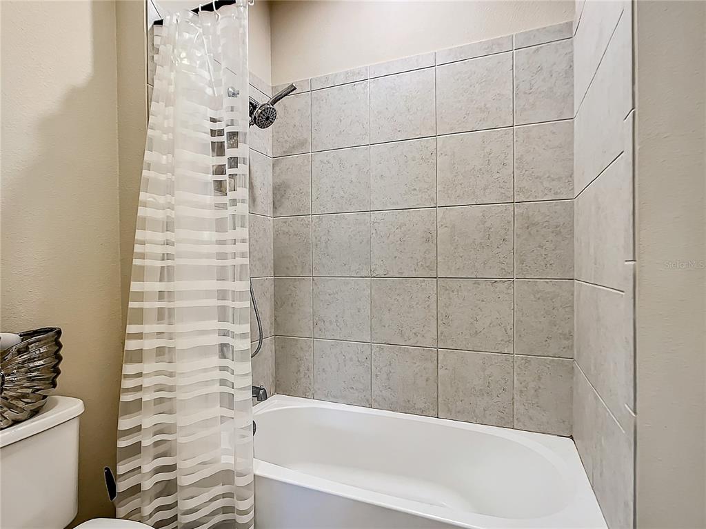 4744 Wandering Way Wesley Chapel, FL 33544 - Photo 28 of 39 a bathroom with a bathtub