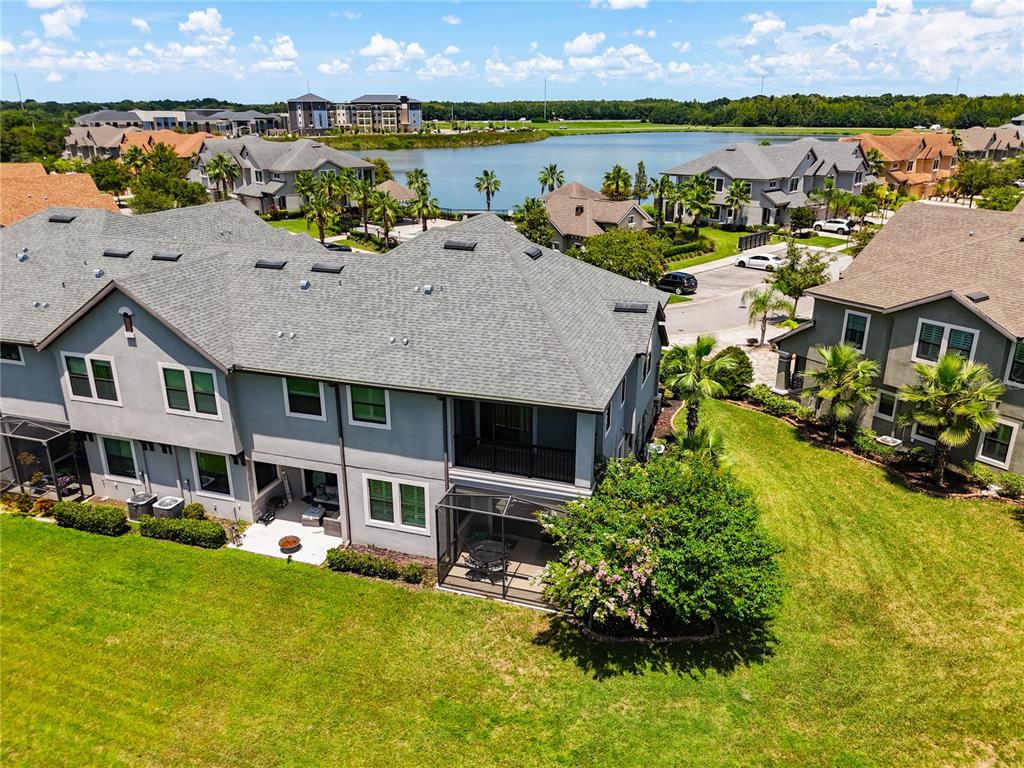 4744 Wandering Way Wesley Chapel, FL 33544 - Photo 39 of 39 a aerial view of a house with swimming pool and ocean view