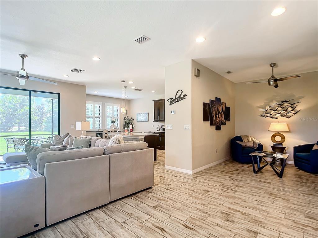 4744 Wandering Way Wesley Chapel, FL 33544 - Photo 8 of 39 a living room with furniture window and wooden floor