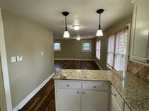 3014 22nd Street Lubbock, TX 79410 - Photo 3 of 23 a kitchen with a sink a counter space and a chandelier