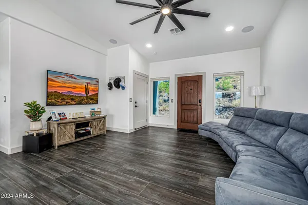 a kitchen with stainless steel appliances granite countertop a sink dishwasher and white cabinets with wooden floor