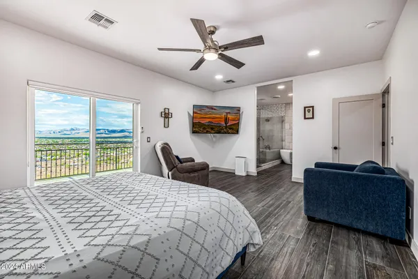 a room with lots of furniture and view of pool