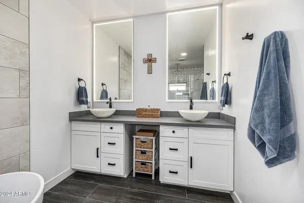 a kitchen with stainless steel appliances a stove a sink a oven a dining table and chairs