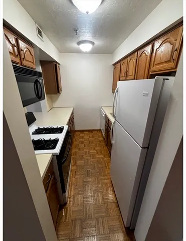 a kitchen with stainless steel appliances a refrigerator and a stove top oven