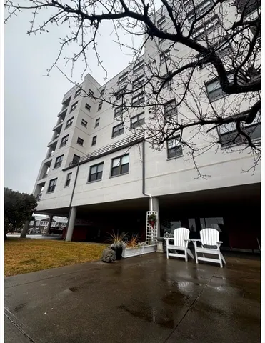 a front view of a building with glass top table and chairs