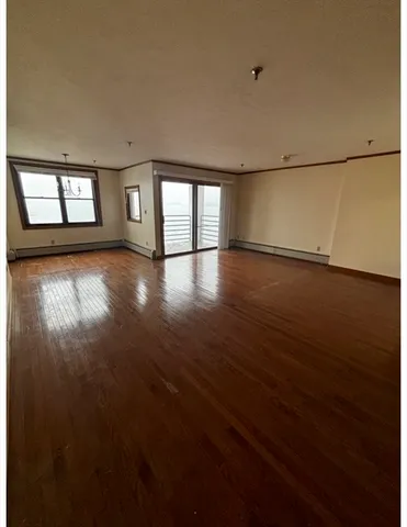 a view of a room with stairs and a floor to ceiling window