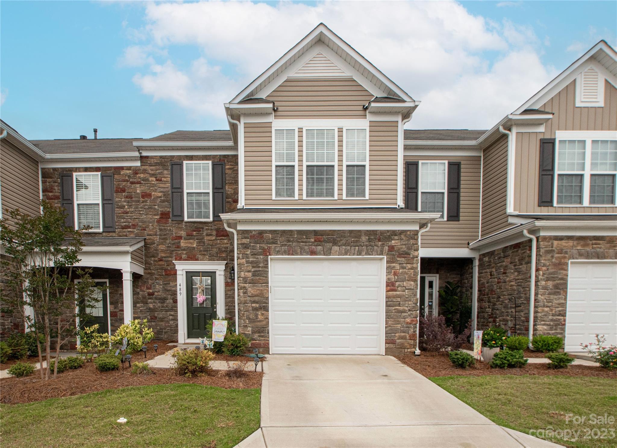 a front view of a house with a yard