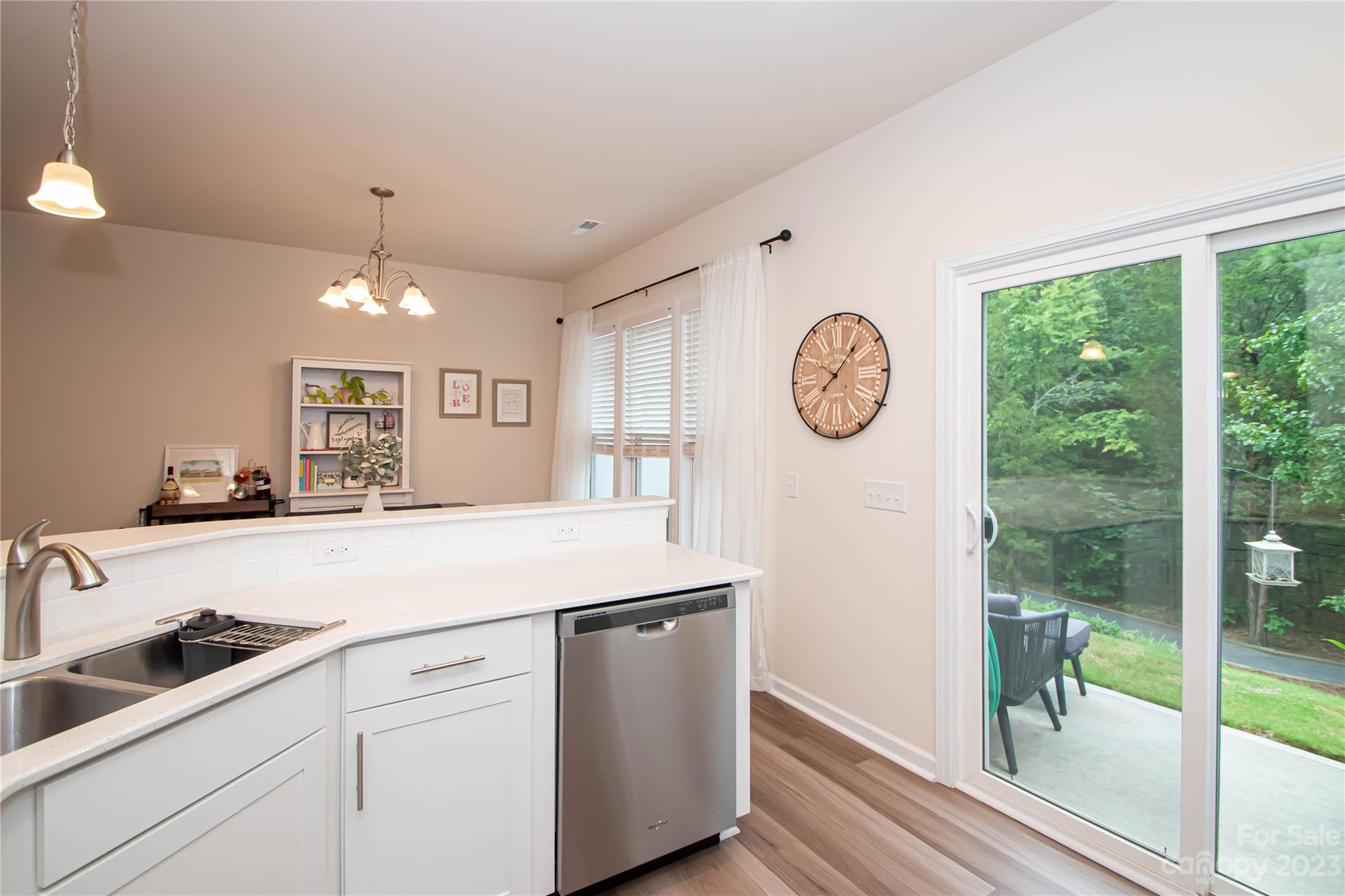 489 Hunters Dance Road Fort Mill, SC 29708 - Photo 11 of 36 a kitchen with a sink a large window and a clock