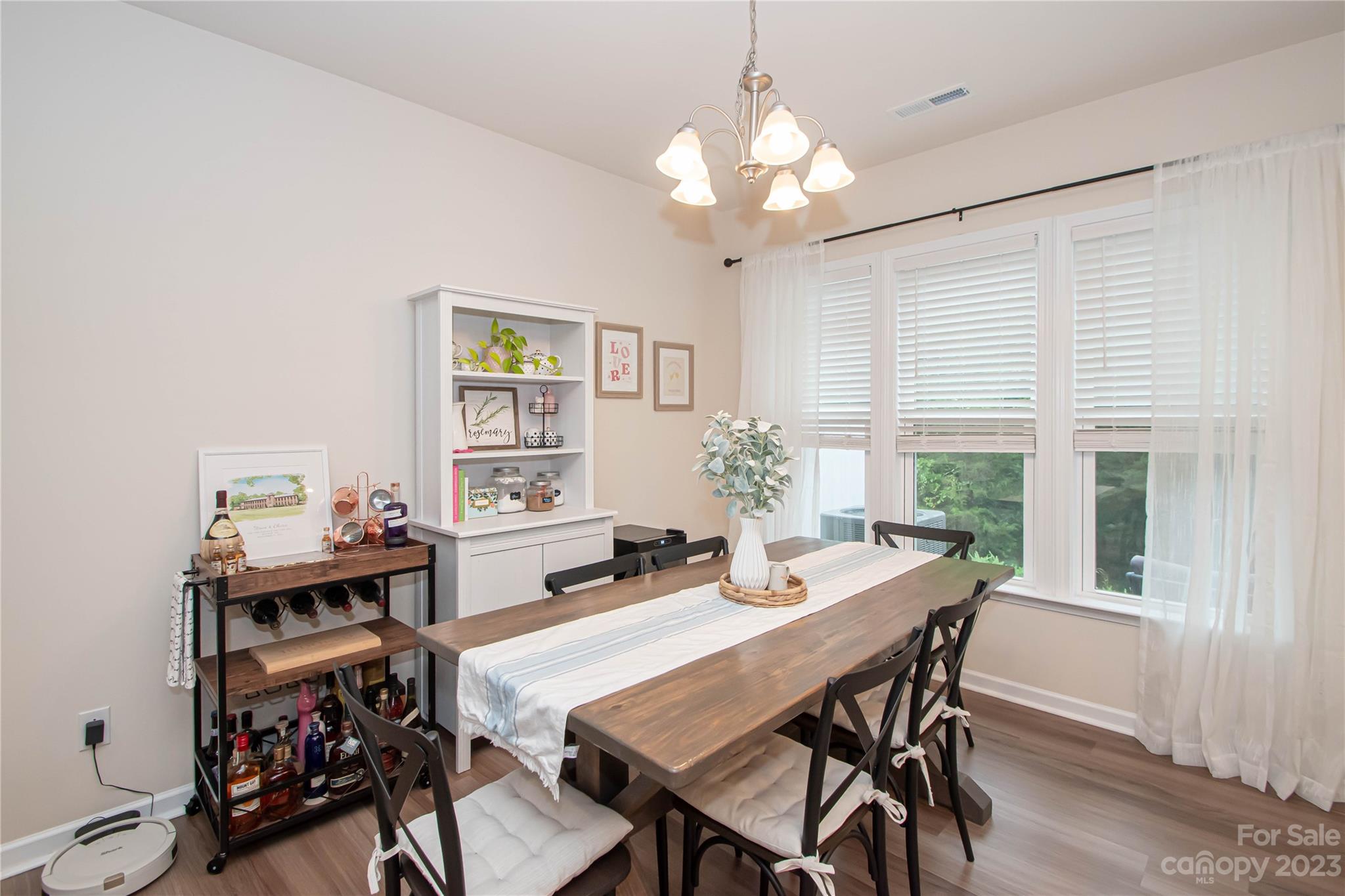 489 Hunters Dance Road Fort Mill, SC 29708 - Photo 7 of 36 a view of a dining room with furniture window and wooden floor