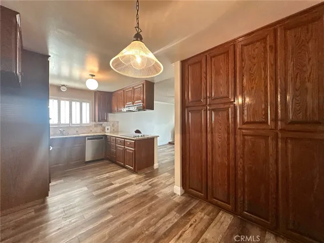a view of a kitchen with a refrigerator and cabinets