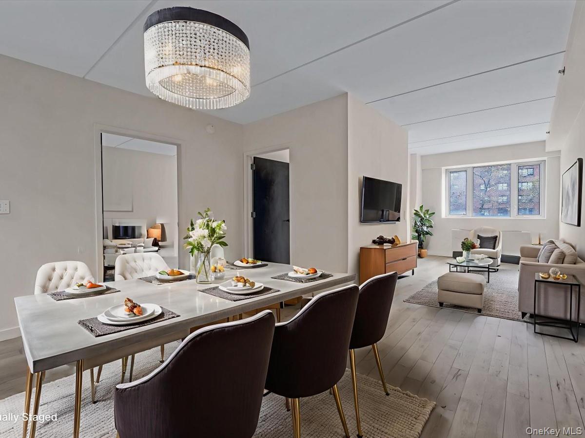 1810 3rd Avenue, Unit A2D Manhattan, NY 10029 - Photo 10 of 19 Dining space with light wood-type flooring and a chandelier