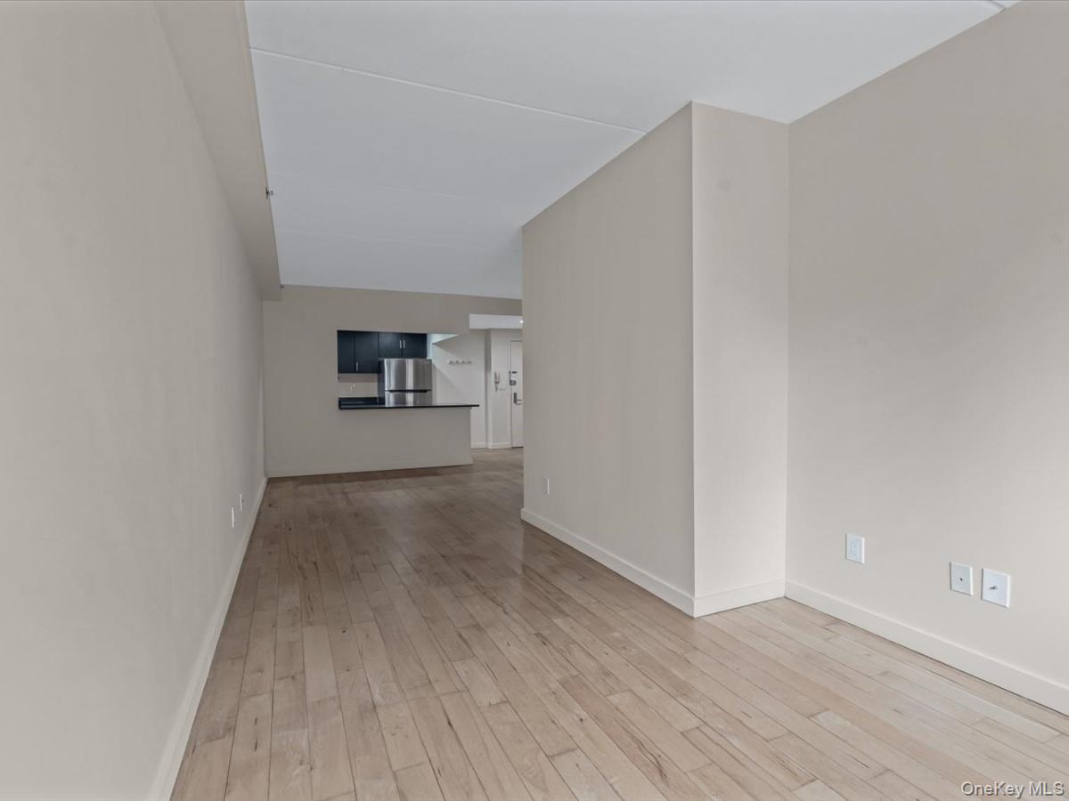 1810 3rd Avenue, Unit A2D Manhattan, NY 10029 - Photo 12 of 19 Unfurnished living room featuring light wood-style flooring and baseboards