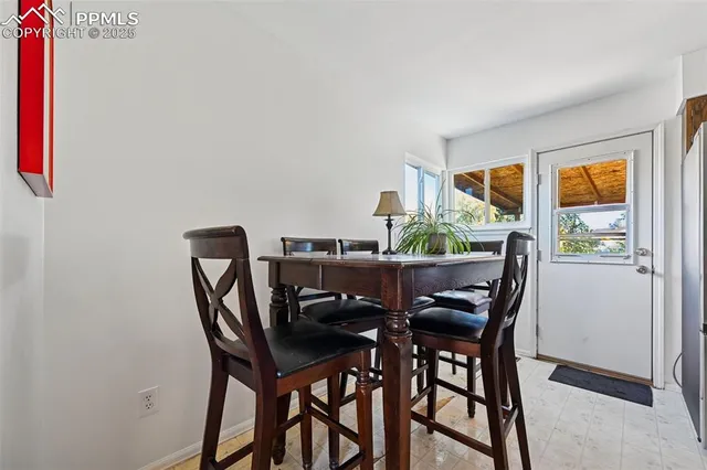 a view of a dining room with furniture and a window