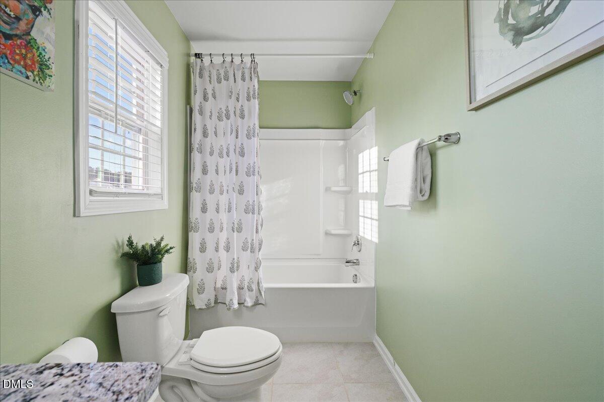 7804 Charters End Street Willow Spring, NC 27592 - Photo 29 of 43 a bathroom with a toilet a sink and a shower