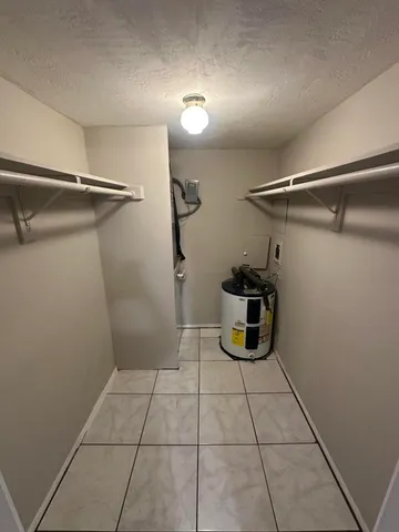 a bathroom with a toilet a sink a mirror and shower