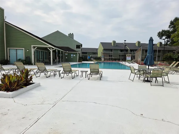a view of a patio with dining table and chairs with potted plants