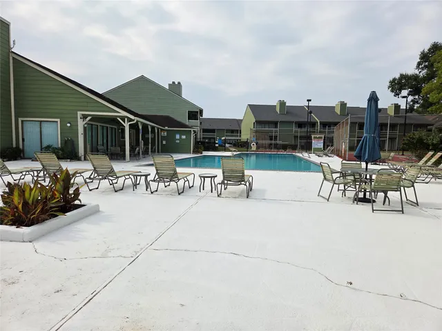 a view of a patio with dining table and chairs with potted plants