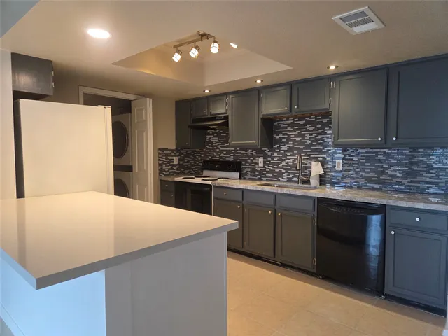 a kitchen with stainless steel appliances a refrigerator sink and microwave