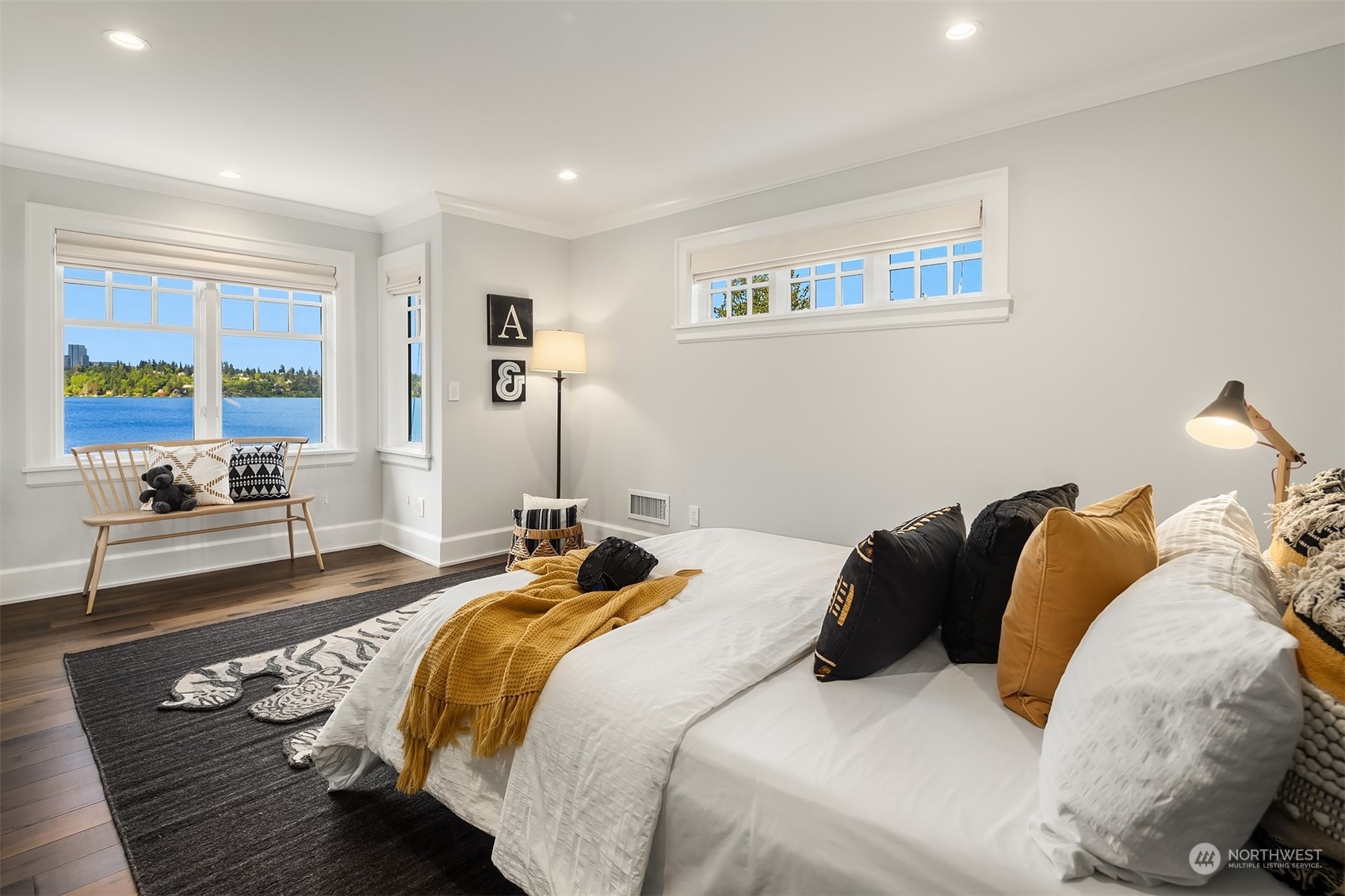 7270 North Mercer Way Mercer Island, WA 98040 - Photo 28 of 40 a bedroom with a bed and glass walk in closet
