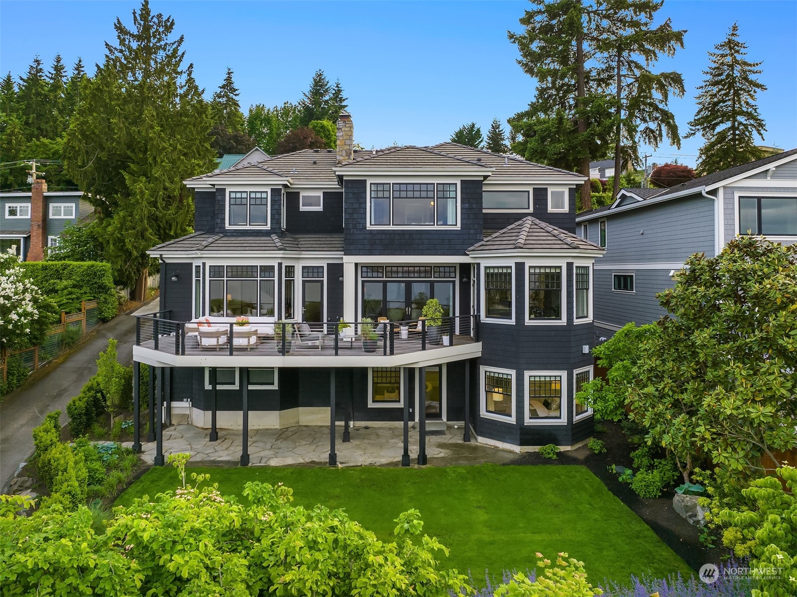 7270 North Mercer Way Mercer Island, WA 98040 - Photo 4 of 40 a front view of a house with a yard table and chairs