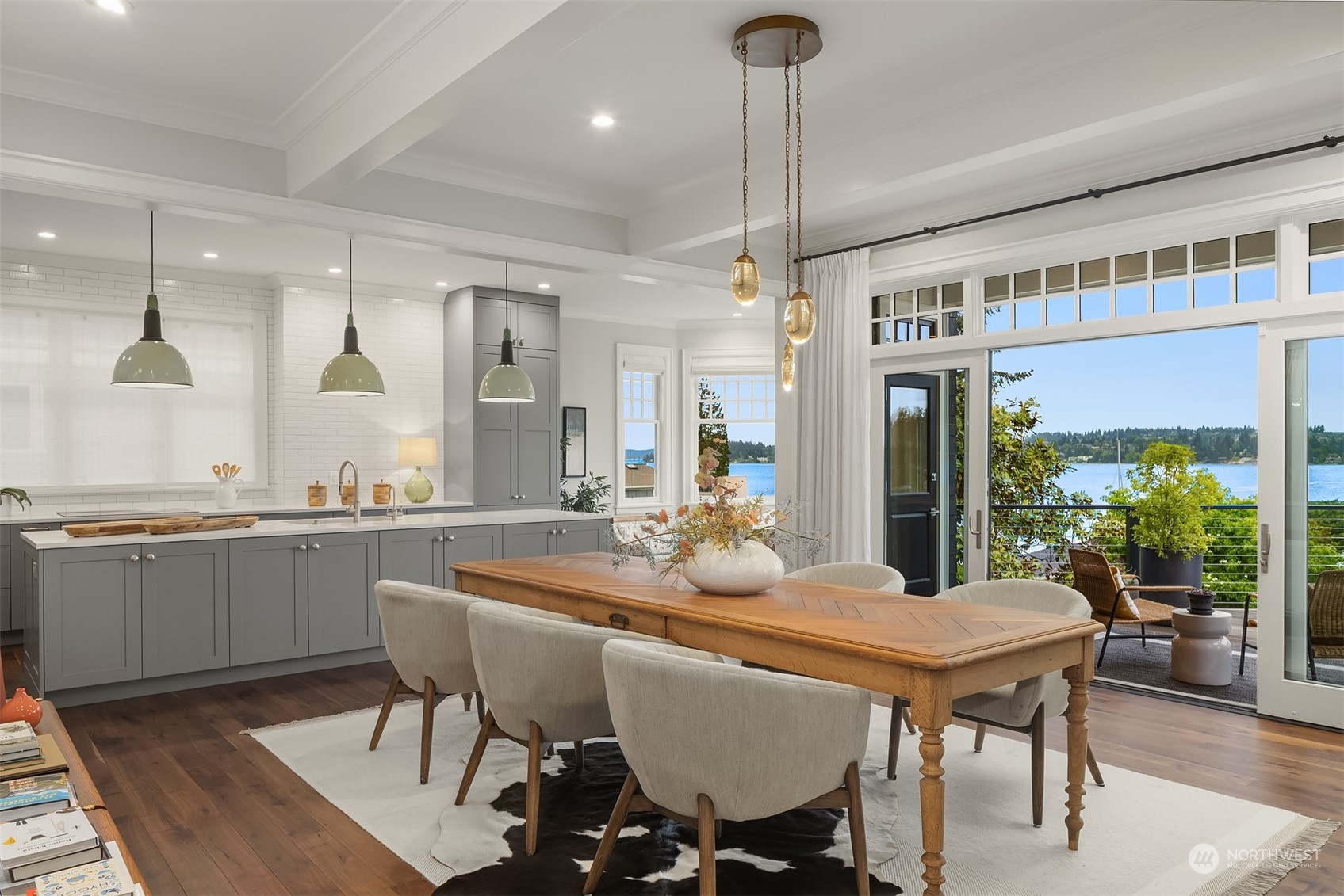 7270 North Mercer Way Mercer Island, WA 98040 - Photo 9 of 40 a dining room with stainless steel appliances granite countertop a table chairs and a chandelier