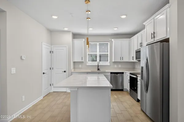 a bedroom with a bed and a flat tv screen on dresser