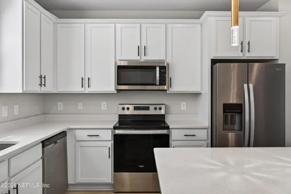 an empty room with closet and a hallway