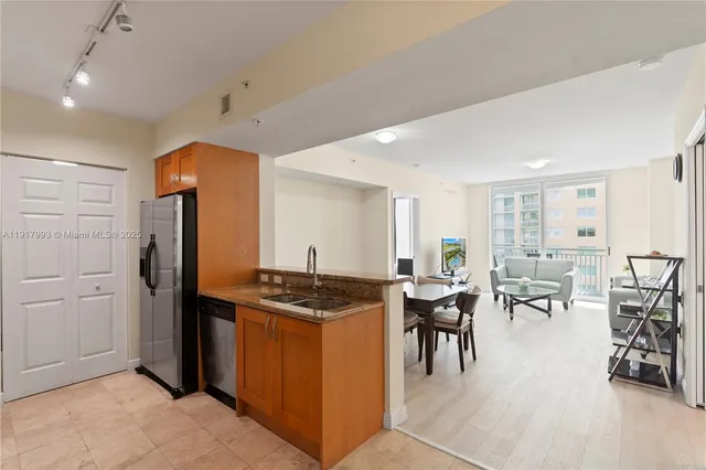 a kitchen with stainless steel appliances granite countertop a stove and a refrigerator