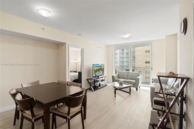 a view of a dining room with furniture and wooden floor