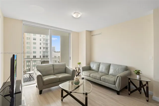 a living room with furniture and a large window