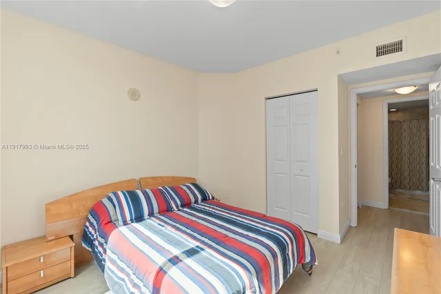 a bedroom with a bed and a couch