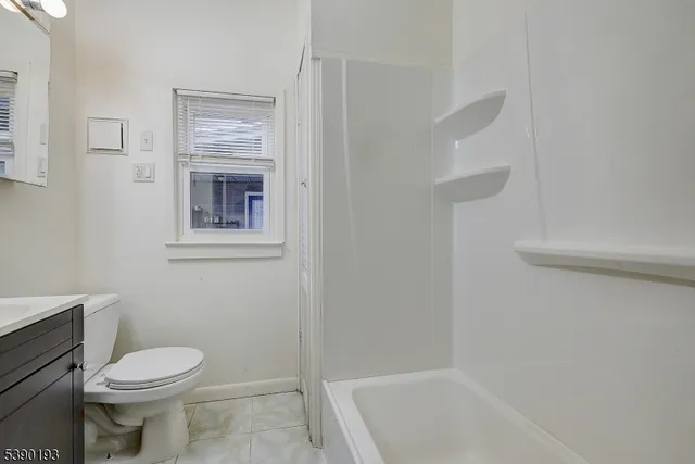 a bathroom with a toilet and a bathtub