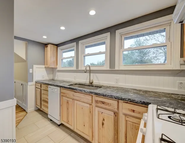 a kitchen with granite countertop a sink and a window
