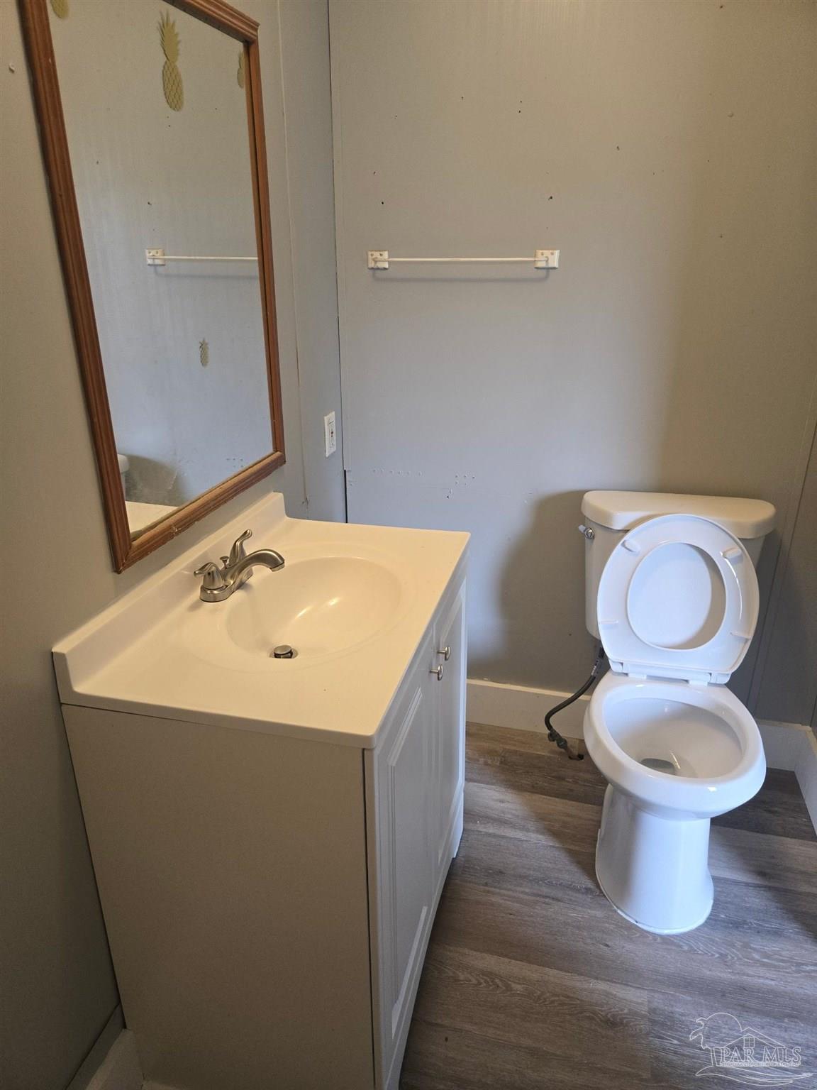 5675 Saufley Field Road, Unit 9 Pensacola, FL 32526 - Photo 14 of 15 a white toilet sitting next to a bathroom sink