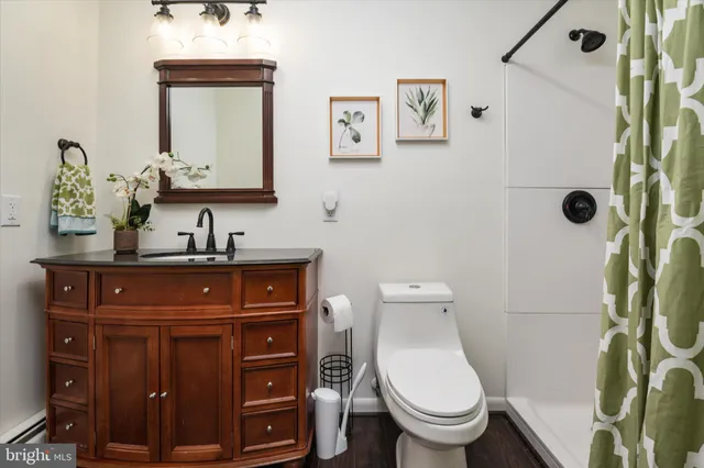 a bathroom with a toilet sink and mirror