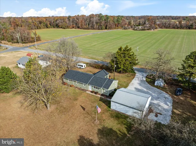 a view of a lake with a yard and large trees