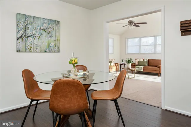 a dining room with furniture and wooden floor