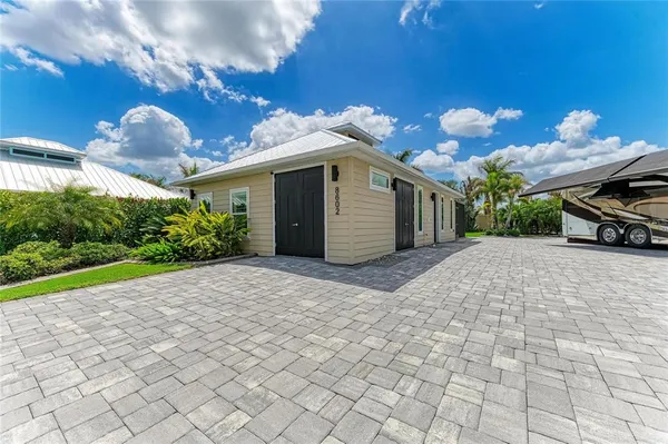a view of a house with a yard and a garage