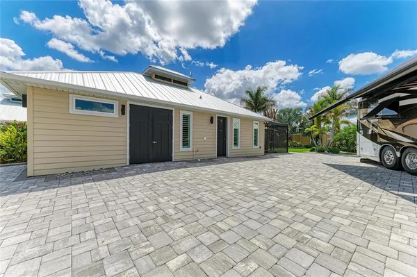 a view of a house with backyard and a barbeque