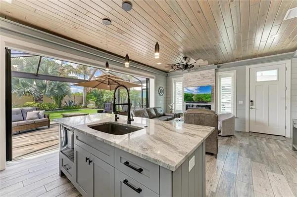 a kitchen with sink refrigerator and large window