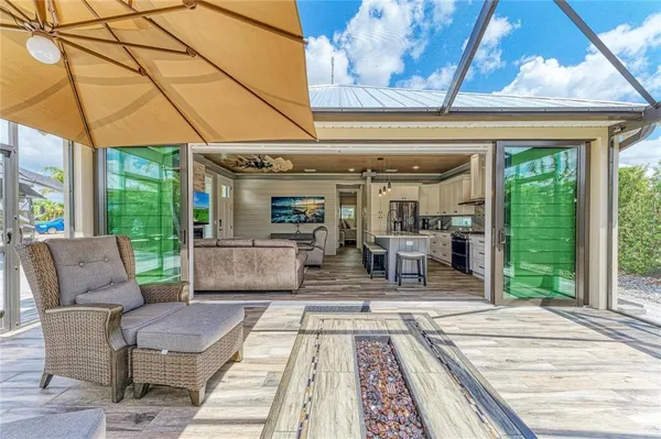a view of a patio with a dining table and chairs with wooden floor