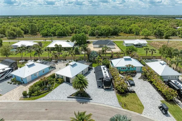 an aerial view of a house with garden space and outdoor seating