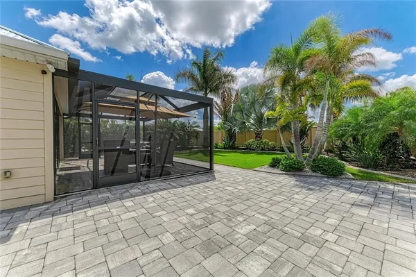 a view of a chairs and bench in backyard of the house